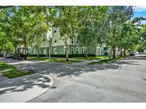 Beautiful green exterior of this multi-story home with manicured landscaping at 501 Water St # 501, Celebration, FL 34747