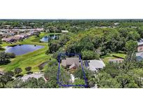 An aerial view of a cozy home surrounded by lush landscaping and a serene pond, a peaceful retreat at 612 Heron Bay Dr, Orlando, FL 32825
