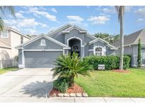 Charming single-story home with a well-manicured lawn and two-car garage at 637 Blenheim Loop, Winter Springs, FL 32708