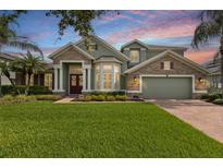 Charming two-story home with a stone and siding exterior, lush lawn, and well-maintained landscaping at 724 Duff Dr, Winter Garden, FL 34787
