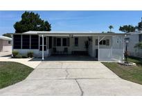 Charming single-story home with covered parking and well-maintained landscaping and beautiful blue skies at 816 Polo Park East Blvd, Davenport, FL 33897