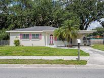 Charming single-story home with a well-maintained lawn and a palm tree in the front yard at 1244 Woodland Ave, Lakeland, FL 33801
