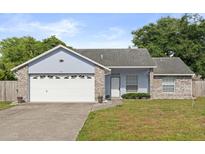 Charming single Gathering home with a two car garage and beautiful front lawn at 1415 Hensley Dr, Deland, FL 32724