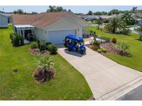 Charming single-Gathering home with a well-maintained lawn and driveway with space for a golf cart at 2167 Kerwood Loop, The Villages, FL 32162