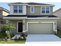 Two-story home with a two-car garage, well-maintained lawn and landscaping, plus stylish neutral exterior paint at 4433 Sagefield Dr, St Cloud, FL 34773