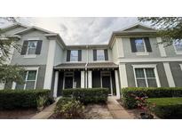 Charming townhome featuring a well-maintained lawn and classic architectural details at 4450 Capital Blvd, St Cloud, FL 34769