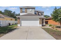 Beautiful two-story home with a spacious driveway and well-maintained landscaping and modern exterior at 5107 Ne 122Nd Blvd, Oxford, FL 34484
