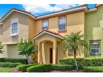 Charming townhome with colorful facade, well-maintained landscaping, and a welcoming entrance at 540 Monroe Cir, Davenport, FL 33896