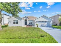 Charming single-story home featuring a well-maintained lawn and a two-car garage at 560 Viceroy Ct, Kissimmee, FL 34758