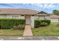 Charming single-story home featuring a well-maintained lawn and tiled walkway at 1156 Lucaya Cir, Orlando, FL 32824