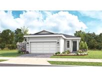 Charming single-story home featuring a two-car garage, well-manicured lawn, and tastefully landscaped garden at 1459 Santorini Way, Tavares, FL 32778