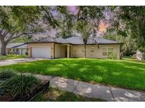 Charming single-story home with a well-maintained lawn and mature trees, creating a welcoming curb appeal at 196 Morning Glory Dr, Lake Mary, FL 32746