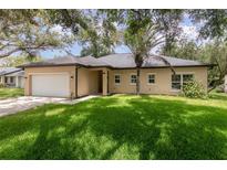 Charming single-story home features a well-maintained lawn, mature trees, and a two-car garage at 196 Morning Glory Dr, Lake Mary, FL 32746