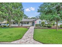 Charming single-story home with lush lawn, brick walkway, and inviting curb appeal at 2450 Mcintosh Way, Maitland, FL 32751