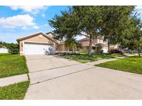 Charming single-Gathering home with a two-car garage and mature landscaping, ready for new homeowners at 3078 Mandolin Dr, Kissimmee, FL 34744