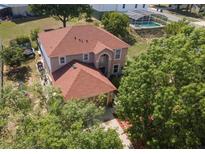 Stunning aerial view of a well-maintained home with a pool and landscaped backyard at 3216 White Blossom Ln, Clermont, FL 34711