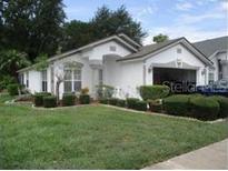 Charming single-story home featuring manicured landscaping and an attached two-car garage at 5760 Arnold Zlotoff Dr, Orlando, FL 32821