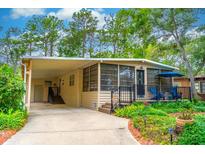 Charming home featuring a covered parking area, front porch and manicured landscaping at 607 W Club Blvd, Lake Mary, FL 32746