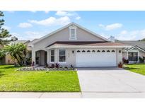 Charming single-story home featuring a well-maintained lawn and a two-car garage, under a sunny sky at 635 Holbrook Cir, Lake Mary, FL 32746