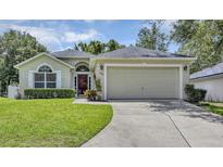 Charming single-story home featuring a well-manicured lawn and a spacious two-car garage at 638 Sun Bluff Ln, Apopka, FL 32712