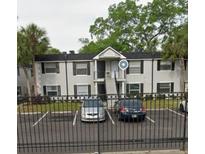 Traditional-style apartment building featuring a gated entrance and convenient parking at 7604 Forest City Rd # 11, Orlando, FL 32810