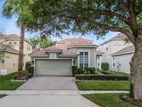 Charming single-story home featuring a brick driveway, two-car garage, and well-maintained landscaping at 8333 Via Verona, Orlando, FL 32836