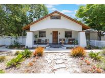 Charming home featuring a welcoming front porch, decorative stone path, and a meticulously landscaped front yard at 1505 Magnolia Ave, Sanford, FL 32771