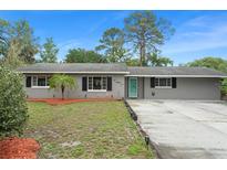 Charming single-story home featuring a well-maintained lawn and a tidy, inviting exterior at 16 Lake Drive, Debary, FL 32713