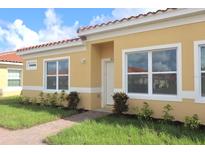 Charming single-story home features a red tile roof, well-maintained lawn, and inviting front entrance at 1800 Coriander Dr, Kissimmee, FL 34759