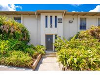 Condo exterior with lush landscaping and a walkway leading to the unit entrance at 200 Maitland Ave # 122, Altamonte Springs, FL 32701