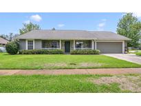 Charming single-story home with stone accents, a well-manicured lawn, and an attached two-car garage at 20330 Majestic St, Orlando, FL 32833