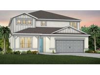 Charming two-story home with gray and white paint, well-manicured lawn, and a two-car garage at 3118 Norcott Dr, Davenport, FL 33837