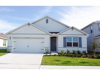 Charming single-Gathering home features a two-car garage, manicured lawn, and inviting entrance, perfect for suburban living at 3412 Wynwood Forest Dr, Ocoee, FL 34761