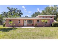 Charming one-story home with a welcoming front yard and manicured landscaping at 360 W University Ave, Orange City, FL 32763
