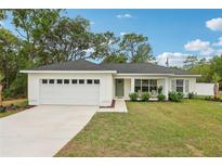 Charming single story home with a two car garage and well-maintained landscaping at 5 Pecan Drive Crse, Ocala, FL 34472