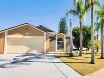 Charming single-Gathering home featuring a large garage, beautiful landscaping and inviting curb appeal at 5371 Lonesome Dove Dr, Kissimmee, FL 34746