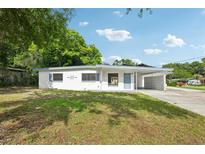 Charming single-story home with a well-manicured lawn, covered carport and freshly painted exterior at 7301 Armstrong Rd, Orlando, FL 32810