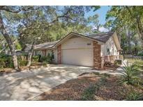 Charming single Gathering house with a two-car garage surrounded by mature trees at 921 Torchwood Dr, Deland, FL 32724