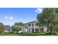 Beautiful two-story home with manicured lawn, lush landscaping, and classic architectural details at 968 Ashton Oaks Cir, Lakeland, FL 33813