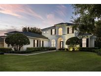 Stunning two-story home featuring lush landscaping and elegant architectural details at 968 Ashton Oaks Cir, Lakeland, FL 33813