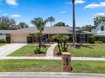 Charming single-story home with a well-manicured lawn, beautiful landscaping, and inviting curb appeal at 986 Stonewood Ln, Maitland, FL 32751