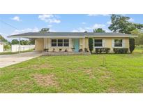 Charming single-story home featuring a well-manicured lawn and a covered carport at 136 Triplet Lake Dr, Casselberry, FL 32707