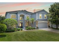 Charming two-story home with a manicured lawn, complemented by lush landscaping and a two car garage at 1467 Selbydon Way, Winter Garden, FL 34787