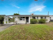 Charming single-story home featuring a carport and well-maintained front lawn at 1623 Crestlawn Ave, Orlando, FL 32811