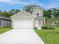 Charming home featuring a two-car garage, manicured lawn, and classic architectural details at 164 14Th Ave, Longwood, FL 32750