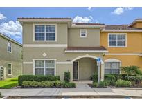 Inviting two-story townhome with a tile roof, manicured landscaping, and an accessible entrance at 3055 Beach Palm Ave, Kissimmee, FL 34747