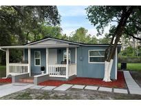 Charming single story home featuring a covered porch, complemented by a freshly landscaped yard and walkway at 4515 Isaac Ln, Sanford, FL 32771