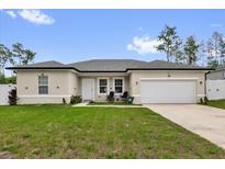 Charming single-story home with a well-manicured lawn, two rocking chairs, and an attached two-car garage at 606 Marion Oaks Blvd, Ocala, FL 34473