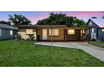 Charming single-story home with a covered porch and well-maintained lawn at 606 Ohio Ave, St Cloud, FL 34769