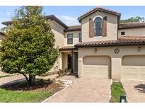 Charming townhome featuring a tile roof, brick driveway, and a one-car garage at 8187 Roseville Rd, Davenport, FL 33896